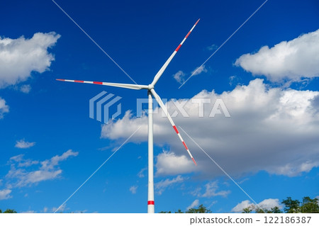 Wind turbine generating clean renewable energy on a blue sky background. Wind turbine generating clean renewable energy on a blue sky background. 122186387