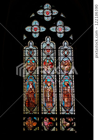 Stained glass church window in the gothic style depicting religious figures. 122186390