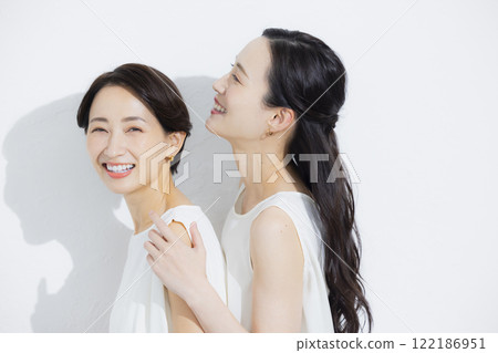 Two cuddling women 122186951