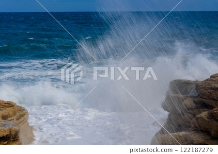 Majestic Sea Spray on Rocky Shores Coastal Bliss winter time stormy day 122187279