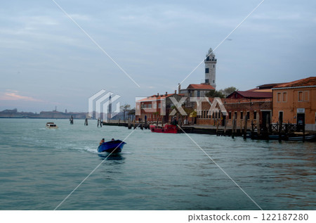 Scenic Venetian Canal with Lighthouse and Boats Explore Murano Scenic Venetian Canal with Lighthouse and Boats Explore Murano 122187280
