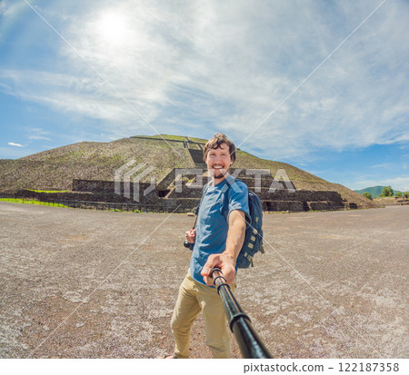 Male tourist exploring Teotihuacan, Mexico. Solo traveler walking through ancient pyramids and ruins at sunrise. Concept of cultural heritage, archaeology, and Mexican tourism Male tourist exploring Teotihuacan, Mexico. Solo traveler walking through ancient pyramids and ruins at sunrise. Concept of cultural heritage, archaeology, and Mexican tourism 122187358