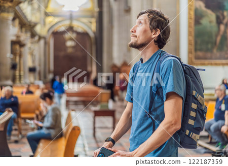 Man tourist exploring the grandeur of Catedral de Puebla, Mexico. Captivating architecture, cultural heritage, and a historic travel experience in one of Mexico's iconic landmarks Man tourist exploring the grandeur of Catedral de Puebla, Mexico. Captivating architecture, cultural heritage, and a historic travel experience in one of Mexico's iconic landmarks 122187359