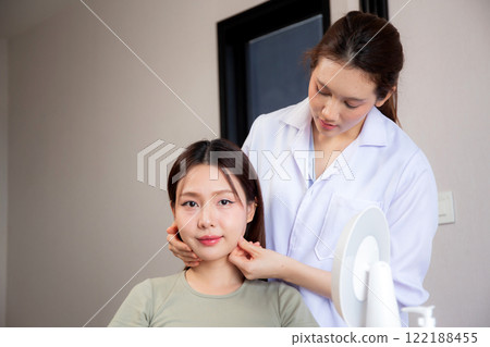 Young asian patient woman consulting with doctor in coat about wrinkle and skin for rejuvenate. 122188455