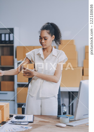 Portrait of Starting small businesses SME owners female entrepreneurs working on receipt box and check online orders to prepare to pack the boxes, sell to customers, SME business ideas online. 122188686