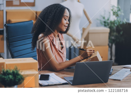 Portrait of Starting small businesses SME owners female entrepreneurs working on receipt box and check online orders to prepare to pack the boxes, sell to customers, SME business ideas online. 122188716