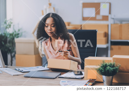 Portrait of Starting small businesses SME owners female entrepreneurs working on receipt box and check online orders to prepare to pack the boxes, sell to customers, SME business ideas online. Portrait of Starting small businesses SME owners female entrepreneurs working on receipt box and check online orders to prepare to pack the boxes, sell to customers, SME business ideas online. 122188717