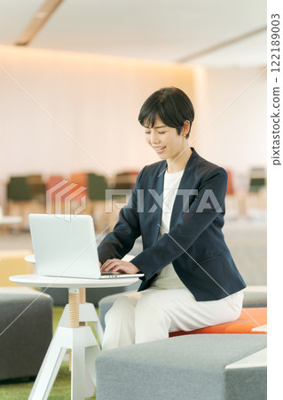 A woman in a suit working in a free office A woman in a suit working in a free office 122189003