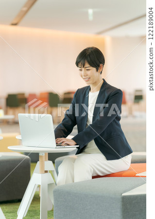 A woman in a suit working in a free office A woman in a suit working in a free office 122189004