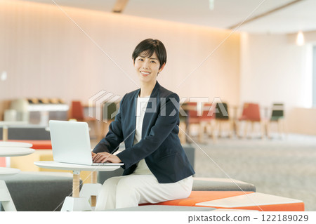 A woman in a suit working in a free office A woman in a suit working in a free office 122189029