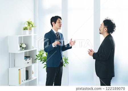 A businessman talking in the lobby 122189070