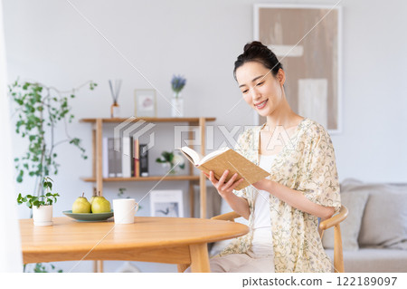 Young woman reading at home Young woman reading at home 122189097