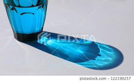 Beautiful shadows and light reflections through the blue glass of water Beautiful shadows and light reflections through the blue glass of water 122190257
