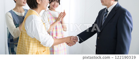 Images of handshakes for childcare workers and caregivers regarding wages, salary increases, and housekeeping contracts 122190319