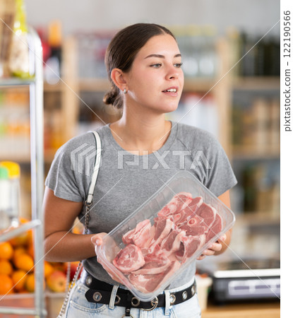 Woman chooses a lamb 122190566