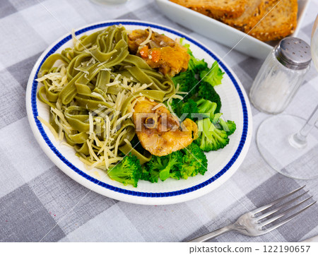 Traditional Italian pasta with meat additive - chicken in cream sauce and broccoli. 122190657