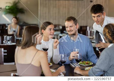 Waiter takes order from couple of men and women Waiter takes order from couple of men and women 122190737