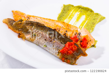 Roasted trout fillet with sauces 122190824