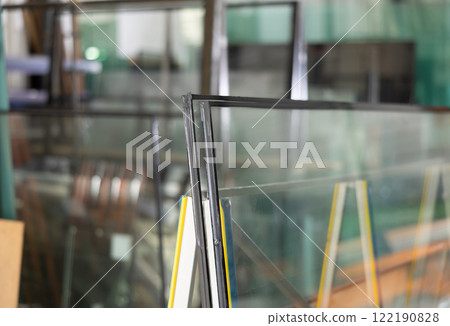 Insulated glass units stacked on support stand in workshop 122190828