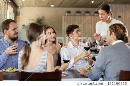 Waitress takes order from group of friends Waitress takes order from group of friends 122190835