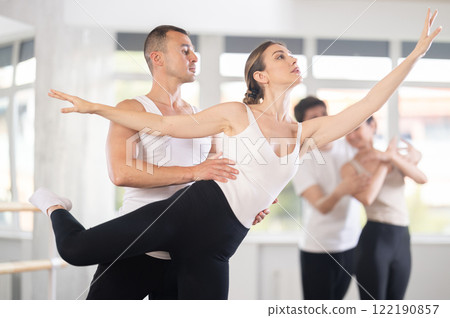 Young man and young woman rehearsing pair ballet Young man and young woman rehearsing pair ballet 122190857