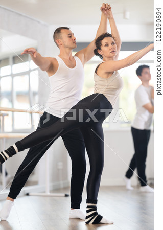 Young man and adult woman rehearsing pair ballet 122190894