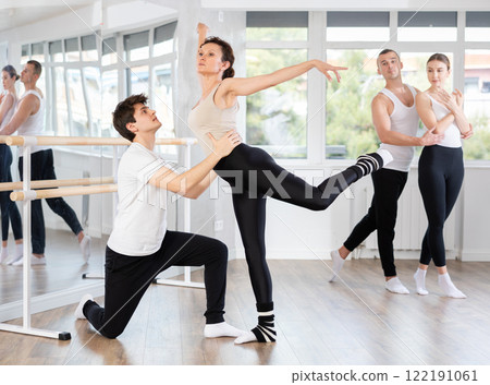 Young guy and adult woman rehearsing pair ballet 122191061