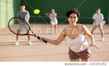 Woman playing frontenis on outdoor pelota court Woman playing frontenis on outdoor pelota court 122191152