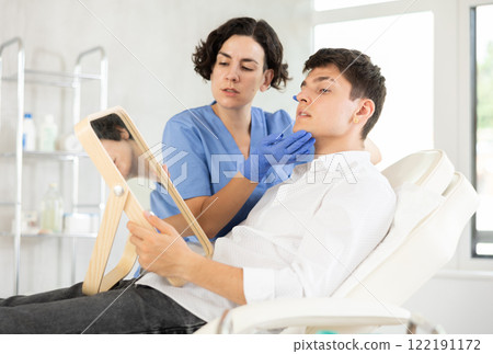 male patient with mirror male patient with mirror 122191172