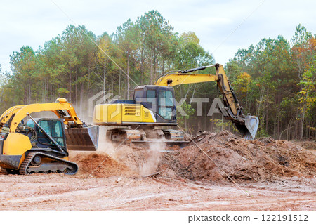 During an earthworks project, small tractor is used to level ground 122191512