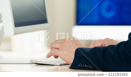 Hands of a man working on a computer Hands of a man working on a computer 122191565