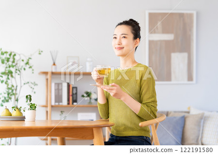 A young woman drinking herbal tea A young woman drinking herbal tea 122191580