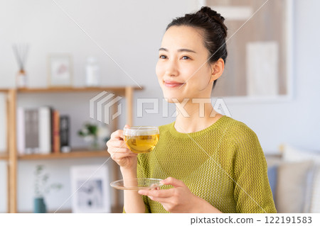 A young woman drinking herbal tea A young woman drinking herbal tea 122191583
