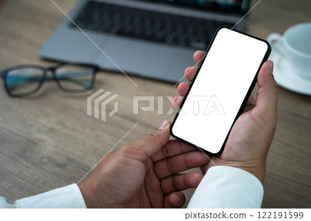 A man is holding a cell phone with a white screen A man is holding a cell phone with a white screen 122191599