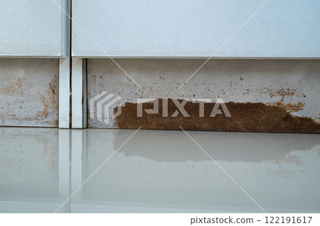 the closet with a white cabinet and a brown stain on the floor 122191617