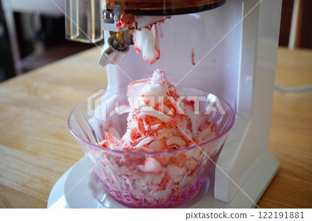 Frozen strawberry shaved ice made by shaving delicious frozen strawberries using a shaved ice machine. Frozen strawberry shaved ice made by shaving delicious frozen strawberries using a shaved ice machine. 122191881