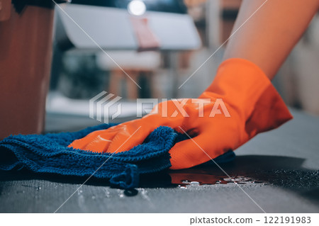 Janitor wiping table in office Janitor wiping table in office 122191983