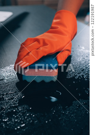 Janitor wiping table in office 122191987