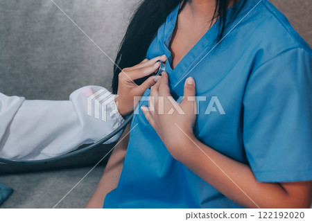 Doctor using stethoscope and examining patient 122192020