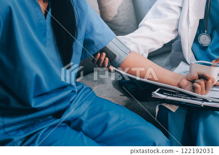 The doctor woman hand use the pulse meter to measure the pressure of the patient, medical checkup concept. The doctor woman hand use the pulse meter to measure the pressure of the patient, medical checkup concept. 122192031