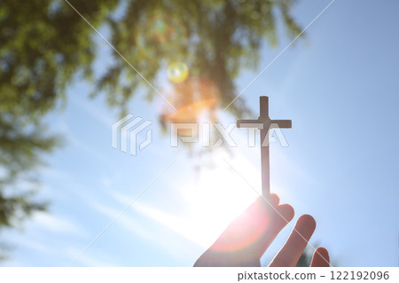 Beautiful sky and sun shining through trees, background of the cross of salvation of Jesus Christ 122192096
