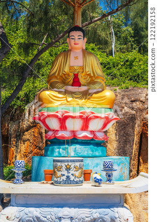 An altar with a sitting Buddha on the territory of a Buddhist temple in Asia. An altar with a sitting Buddha on the territory of a Buddhist temple in Asia. 122192158
