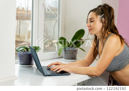 Womans casual attire and serene workspace, adorned with indoor plants 122192192