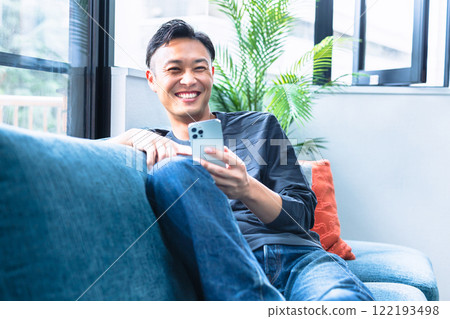 A man who uses a smartphone A man who uses a smartphone 122193498