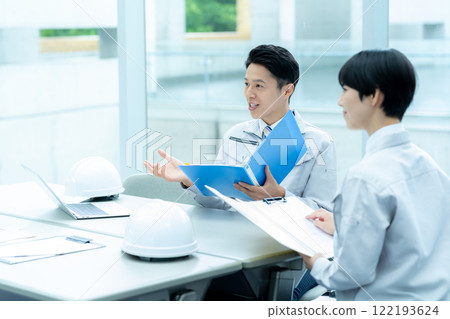 Businessmen in work clothes having a meeting 122193624
