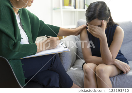 Asian psychologist doctor having session with young depressed woman in clinic. Psychology and mental therapy concept. 122193710