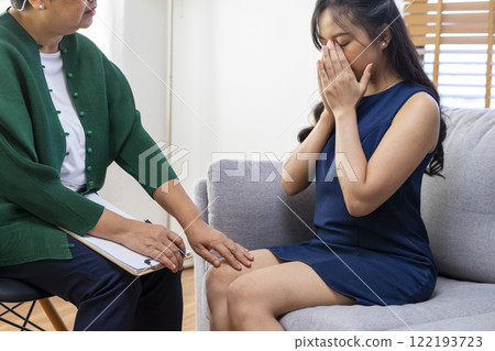 Asian psychologist doctor having session with young depressed woman in clinic. Psychology and mental therapy concept. 122193723