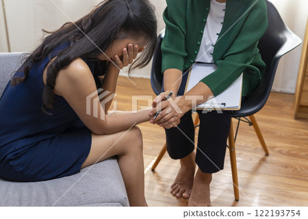 Asian psychologist doctor having session with young depressed woman in clinic. Psychology and mental therapy concept. Asian psychologist doctor having session with young depressed woman in clinic. Psychology and mental therapy concept. 122193754