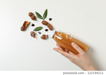 Tamarind juice in a glass bottle on a light background 122194211
