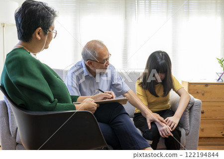 Parents telling the psychologist about family or child problems. Depressed girl and her parent or grandpa having session with psychiatrist in clinic. Parents telling the psychologist about family or child problems. Depressed girl and her parent or grandpa having session with psychiatrist in clinic. 122194844